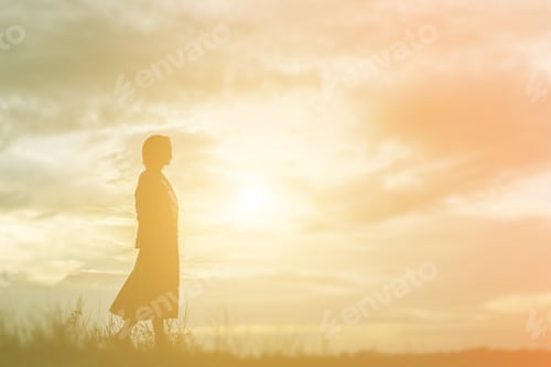 Preview: Silhouette Of Woman Praying Over Beautiful Sky Background