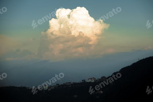Preview: A Beautiful Mixture Of White And Gray Clouds Above A Town On Vast Hills Before Sunset