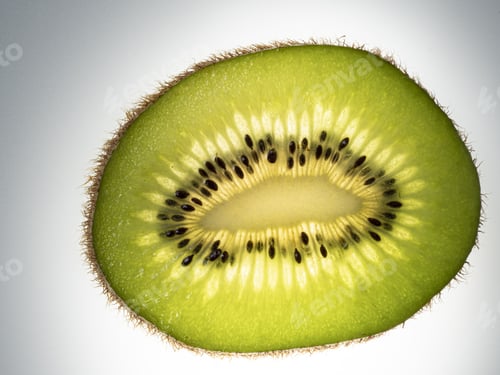 Preview: A Closeup Shot Of Sliced Kiwi Fruit With Dark Small Seeds And Bright Green Flesh On A White