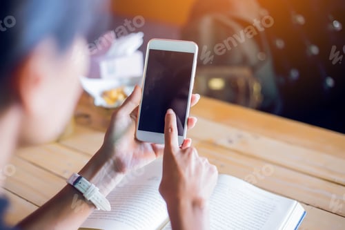 Preview: A Beautiful Woman Wearing A White Dress Using Mobile Phone In A Cafe.