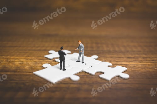 Preview: Miniature People: Businessman Standing On Jigsaw With Wooden Background : Business Concept.