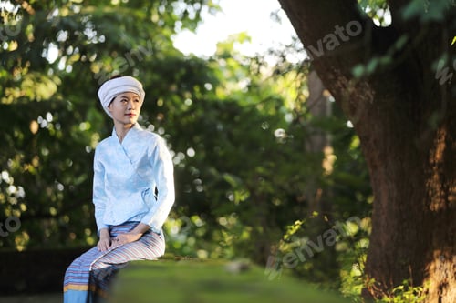 Preview: Portrait Of Thai Young Woman With Traditional Thai Dress Sit In Thai Temple With Tree And Sunrise