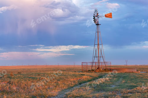 Preview: An Old Vintage Windmill Against A Cloudy Sky At Sunset