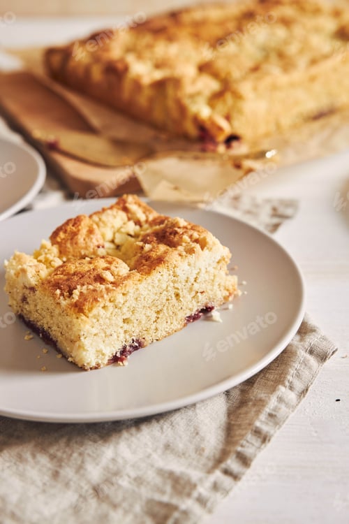 Preview: A Vertical Picture Of A Piece Of Delicious Jerry Crumble Sheet Cake On A White Wood Table - Perfect
