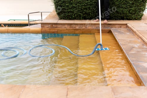 Preview: Worker Cleaning Swimming Pool With Vacuum Tube In The Morning.