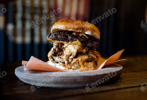 Preview: A Closeup Shot Of A Tasty Hamburger On A Wooden Plate In The Restaurant