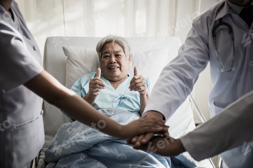 Preview: Close Up Of Team Doctors Hand Together Before Successful With Duty And Patient Behind Them.