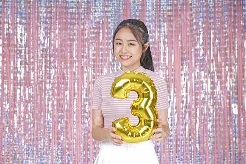 Preview: Asian Young Teenager Pretty Cheerful Beautiful Girl With Party Gold Foil Balloon, On Pink Sparkling