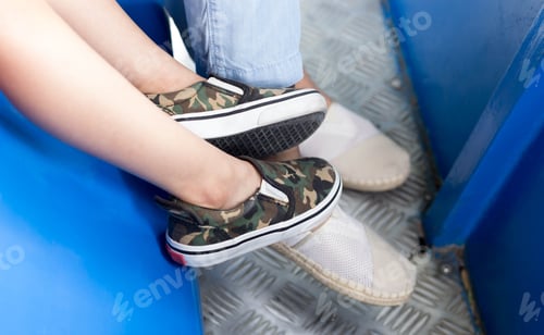 Preview: Little Boy And Mum Sitting On The Tram With Fashion Shoes
