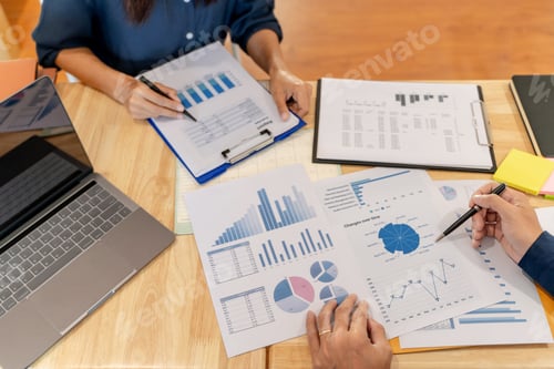 Preview: Two Professionals Reviewing Reports in an Office Setting