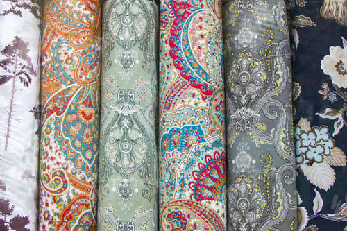 Preview: Rolls of Fabric with Colorful Paisley Patterns