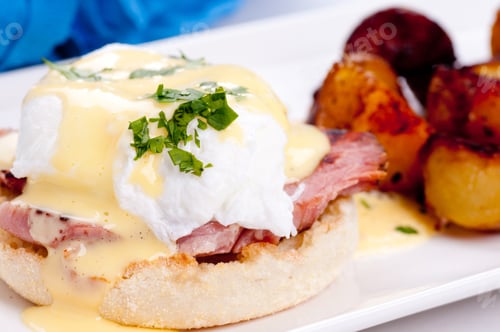 Preview: A Closeup Shot Of Eggs Benedict With Farm Fresh Eggs And Ham And Fried Potatoes