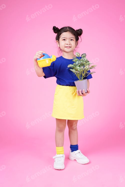 Preview: Happy Asian Cute Little Kid Playing On Pink Background