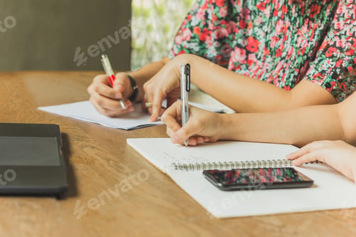 Preview: Business Team Work Sitting At The Table At Cafe And Writing On Documents Paperwork
