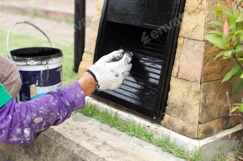 Preview: Hand Painting A Electric Post In Black Color With A Paintbrush