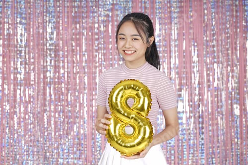 Preview: Asian Young Teenager Pretty Cheerful Beautiful Girl With Party Gold Foil Balloon, On Pink Sparkling