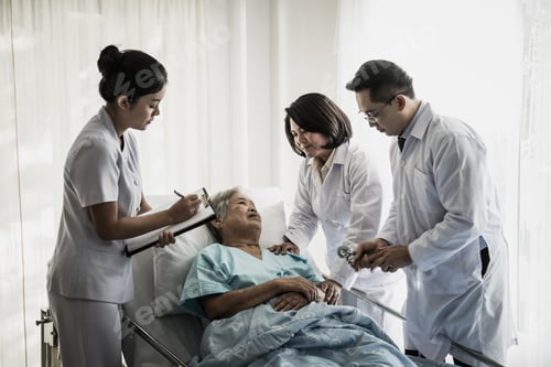 Preview: Medical Team Meeting With Senior Patient In Hospital Room