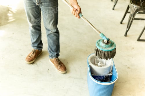 Preview: Man Worker With Mop And Bucket Cleaning Floor In The Cafe