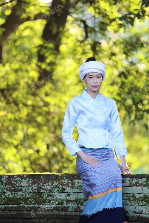 Preview: Portrait Of Thai Young Woman With Traditional Thai Dress In Thai Temple With Tree And Sunrise