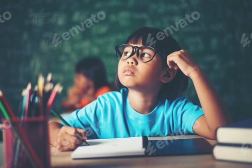 Preview: Thoughtful Little Girl With Book Near A School Board