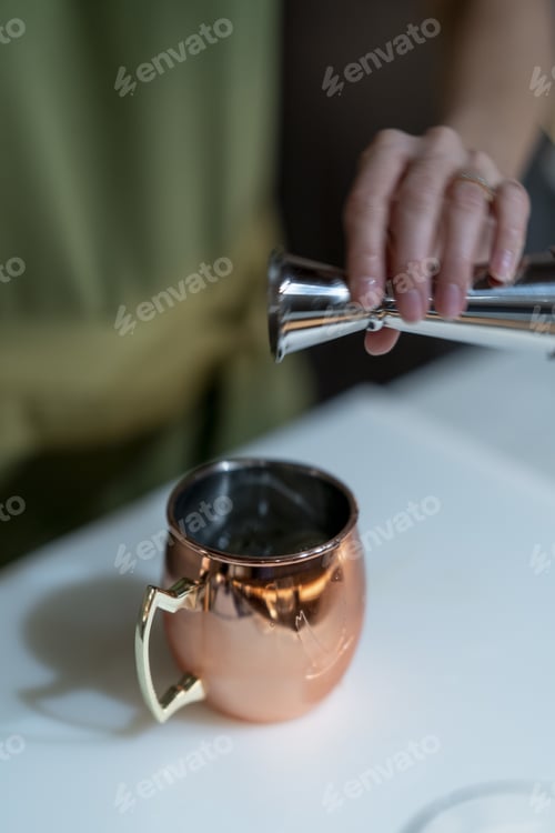 Preview: A Vertical Shot Of A Female Making An Exotic Cocktail In The Bar