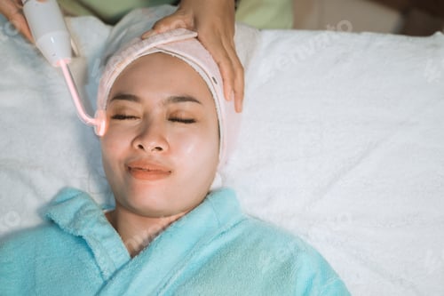 Preview: A Young Woman Looking Relaxed While Wearing A Machine Facial Massage