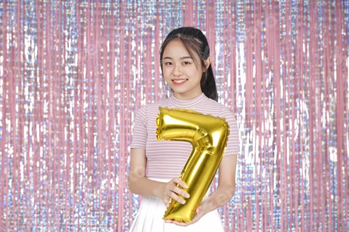 Preview: Asian Young Teenager Pretty Cheerful Beautiful Girl With Party Gold Foil Balloon, On Pink Sparkling