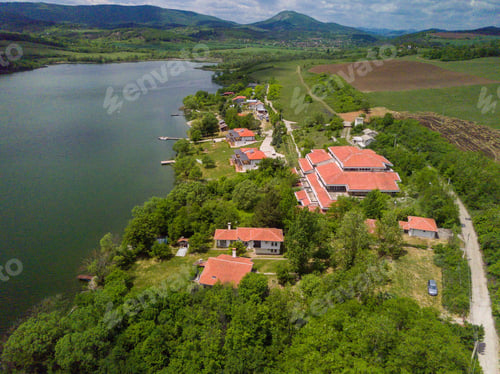 Preview: An Aerial Shot Of The Green Landscapes, Buildingsfields And A River Under The Cloudy Sky On A Sunny