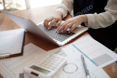 Preview: Accountant Working With Data Documents Calculating On Business Report.