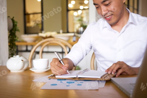 Preview: Handsome Asian Young Man Work From Home With Paper, Notebook