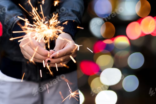 Preview: Yiung Girl Holding A Sparkle With Bokeh Light In Background