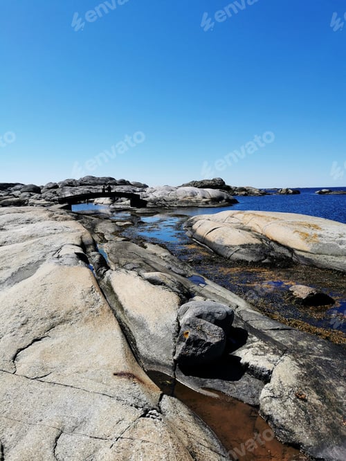 Preview: A Scenic Shot Of A Sea Surrounded By Stone Mountains In Verdens Ende, Norway
