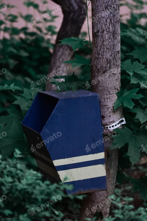 Preview: A Vertical Closeup Shot Of A Blue Metal Mailbox On A Tree
