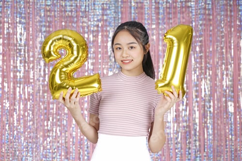 Preview: Asian Young Teenager Pretty Cheerful Beautiful Girl With Party Gold Foil Balloon, On Pink Sparkling