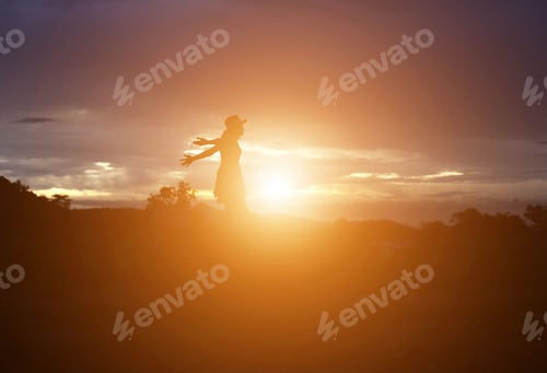 Preview: Silhouette Of Woman Praying Over Beautiful Sky Background