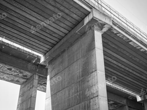 Preview: A Grayscale Low Angle Shot Of A Concrete Bridge