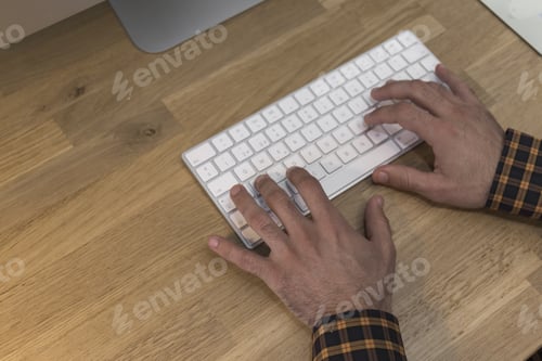 Preview: Closeup Of A Man'S Hands Typing On A White Computer Keyboard