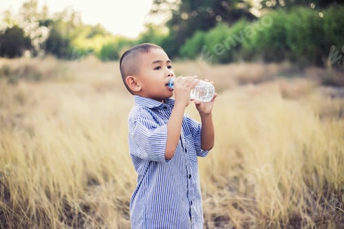 Preview: Little Asian Boy Drinking Water Outdoors