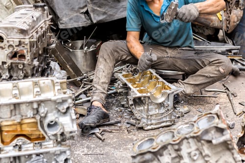 Preview: Labor Working On Engine Spare Parts With Screwdriver And Hammer In Garage