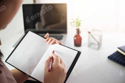 Preview: Young Woman Writing On Notebook At Home.