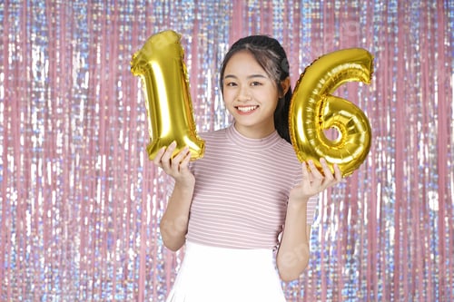 Preview: Asian Young Teenager Pretty Cheerful Beautiful Girl With Party Gold Foil Balloon, On Pink Sparkling