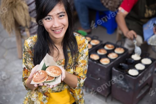 Preview: Apem. Beautiful Asian Woman Wearing Kebaya Showing Indonesian Pancake