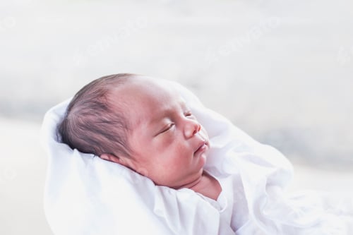Infant Wrapped in White Cloth Sleeping Peacefully