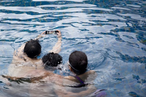 Preview: Selected Focus On Waterproof Cell Phone Group Of Friends Taking Picture In Swimming Pool On Vacation