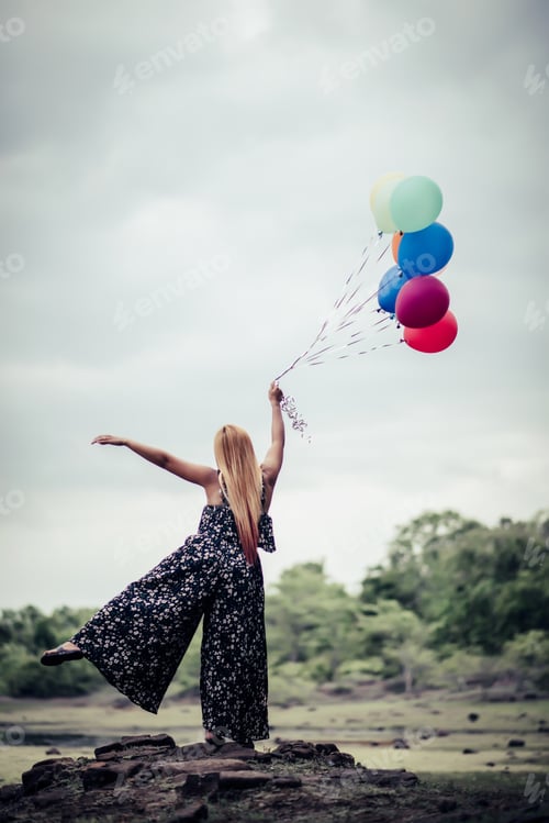 Preview: Young Woman Hand Holding Colorful Balloons