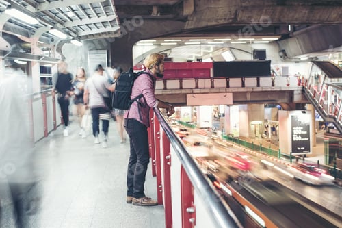 Preview: Hipster Bearded Man Standing In The Train Station With People Motion Background While Traveling At