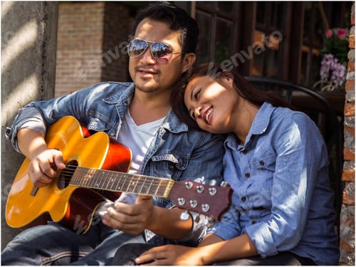 Preview: Hipster Couple Sitting Relaxed With Nice Atmosphere With First Date Enjoys Playing Guitar As A