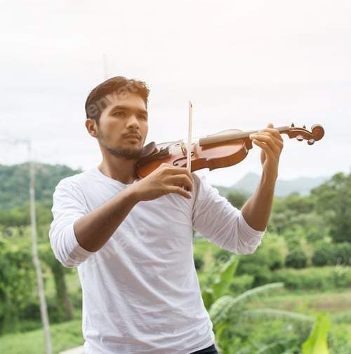 Preview: Young Hipster Musician Man Playing Violin In The Nature Outdoor Lifestyle Behind Mountain.