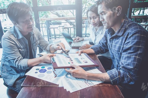 Preview: Businessmen Discussing And Signing Contract During Business Negotiations At Coffee Cafe