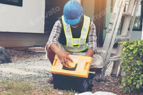 Preview: Construction Worker Working On Equipment Of Tool Box At Construction Site Of New Home